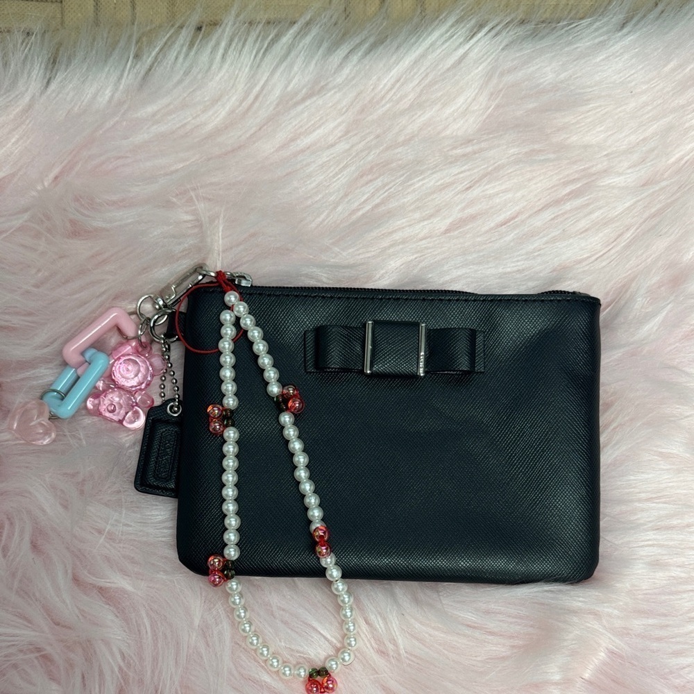 Elegant Black Women's Coach wristlet with bow coquette